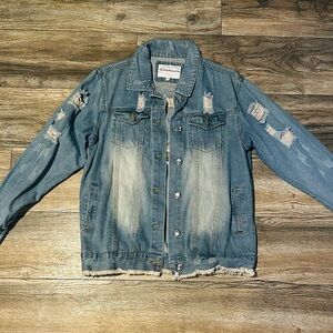 light-wash, distressed denim jacket with rips on the sleeves and front panels